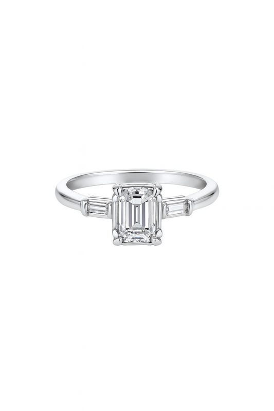 Vintage White Gold Solitaire Diamond Ring with an Emerald Cut Natural Diamond in Centre and Two Baguettes on Sides. 18k TDW: 0.57ct VS2 GH