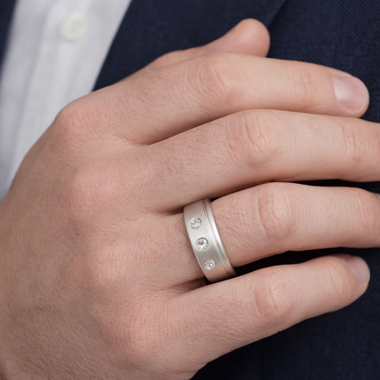 White Gold Matt Style Band setting with Three Natural Diamonds. 18k TDW: 0.06ct