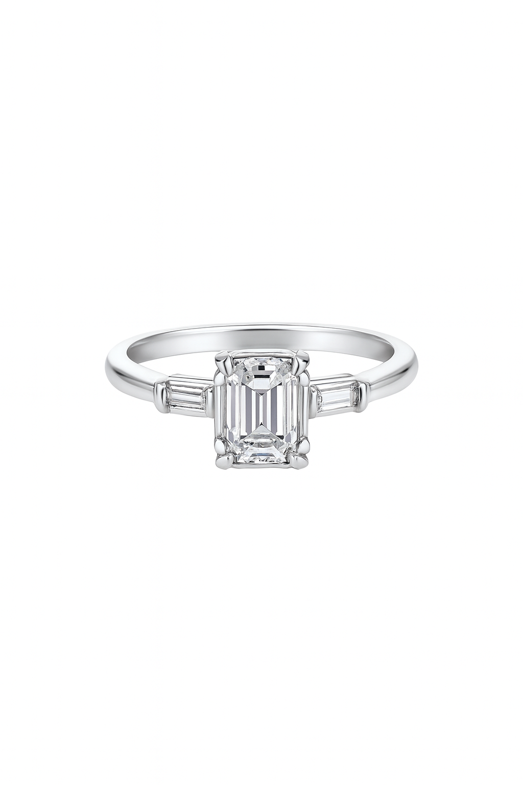 Vintage White Gold Solitaire Diamond Ring with an Emerald Cut Natural Diamond in Centre and Two Baguettes on Sides. 18k TDW: 0.57ct VS2 GH