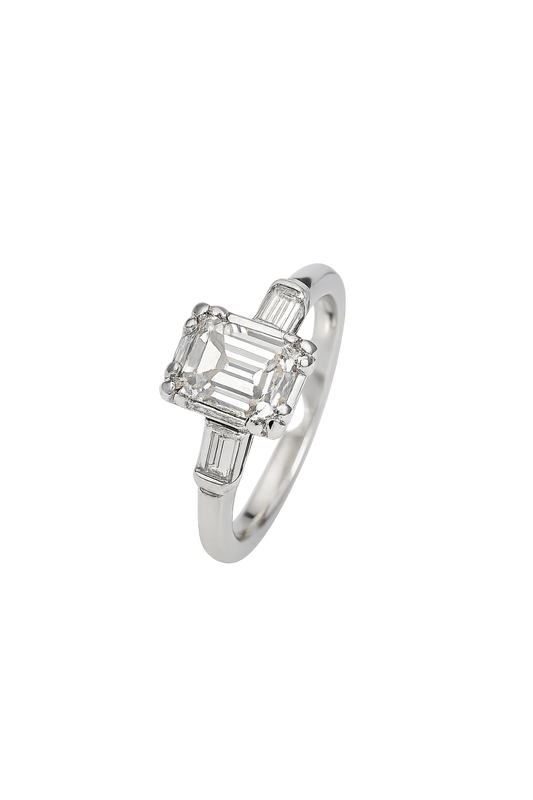 Vintage White Gold Solitaire Diamond Ring with an Emerald Cut Natural Diamond in Centre and Two Baguettes on Sides. 18k TDW: 0.57ct VS2 GH