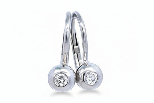 A pair of white gold lever back diamond drop earrings with a round-cut brilliant diamond in each setting.