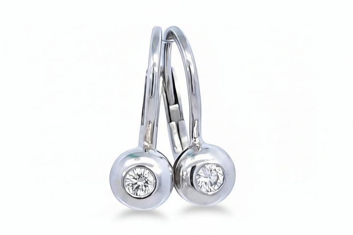 A pair of white gold lever back diamond drop earrings with a round-cut brilliant diamond in each setting.