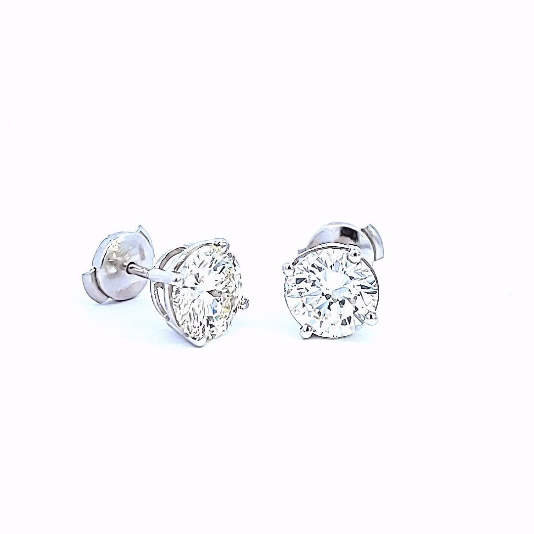 Platinum Stud Earrings with Round Diamonds. One 7.4x7.4x4.4mm 1.5ct VS1 L. One: 7.5x7.6x4.4mm 1.55ct IF M GIA: 3155009754. Pt 3.01gr. TDW: 3.05ct.  IF-VS1 LM