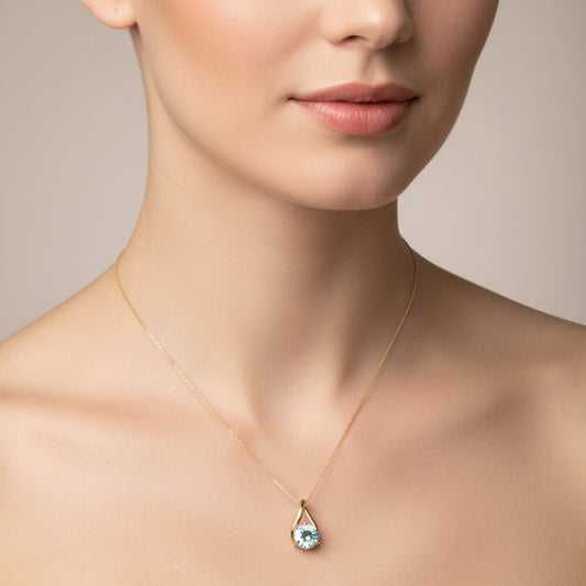 10K Yellow Gold Teardrop Shape Pendant with Blue Topaz.