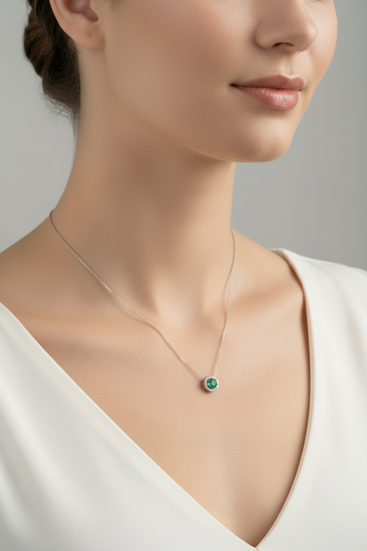 White Gold Floating Round Emerald and Diamond Necklace. 14k E: 0.25ct TDW: 0.25ct